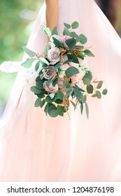 bride's hands hold a beautiful bridal bouquet of roses. fine art photography.