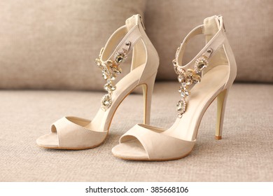 Bride's high heel shoes on sofa
