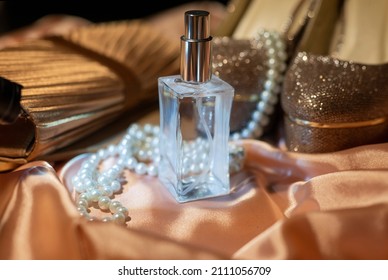 Bride's Morning Beautiful Golden Shoes With A Clutch Bag With Pearl Beads And A Bottle Of Perfume On Silk Fabric