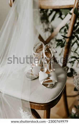 Brides wedding shoes with veil on a chair