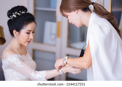 bridesmaid Prepare the bride for the wedding day. Help her dress and accessories. Bride preparation before the wedding ceremony, wedding, engagement, close friends, important day of the bride.