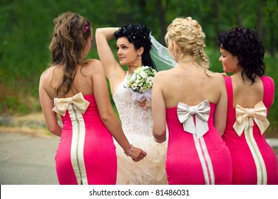 Bridesmaids standing with bride
