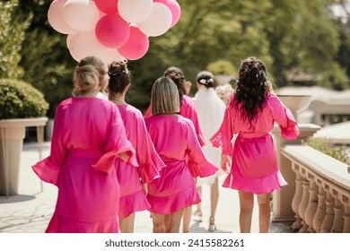 bridesmaids taking a walk in pink dressing gowns - Powered by Shutterstock