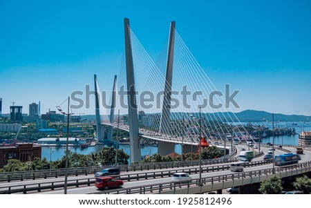 The bridge across the Golden horn bay in Vladivostok in sunny weather. Golden Bridge and view of Vladivostok