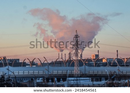 Bridge against the background of smoke from the factory chimneys