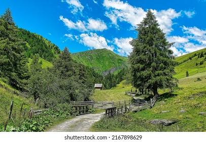A bridge among the hills in the green mountains. Mountain village landscape. Village in mountains. Summer green mountain village landscape