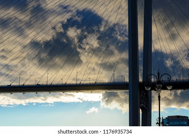 bridge in the background of thunderclouds