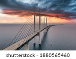 The bridge between Denmark and Sweden, Oresundsbron. Aerial view of the bridge during cloudy stormy weather with lightning.