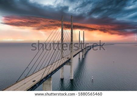 The bridge between Denmark and Sweden, Oresundsbron. Aerial view of the bridge during cloudy stormy weather with lightning.