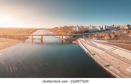 Bridge And Busy City Street Leads Along The Embankment Of A Large River