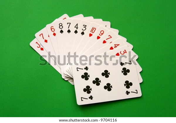 bridge cards - one\
hand (8,7,4,3 spades, 10,9,7,4,3 hearts, J,7,6 diamonds, 7 club) \
background green,