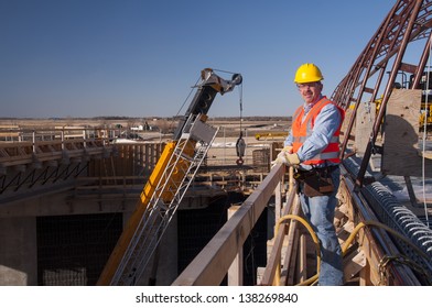 Bridge Construction Worker By Heavy Construction Equipment