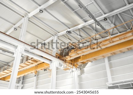 Bridge cranes inside hangar. Overhead cranes inside industrial building