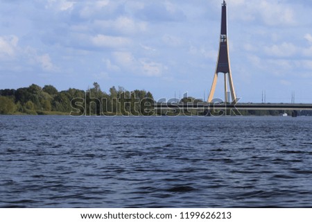 Bridge crosses the river and the island on which Tv Tower is located.