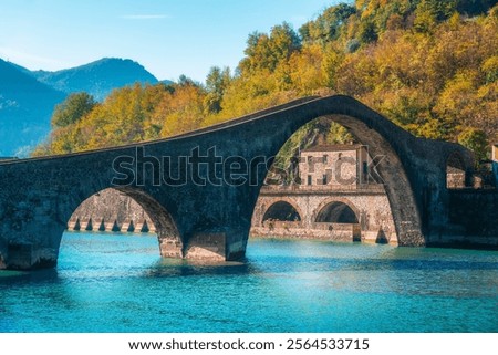 Bridge of the Devil or Ponte della Maddalena historic landmark in Garfagnana in autumn season. Serchio river. Borgo a Mozzano, province of Lucca, Tuscany region, Italy.