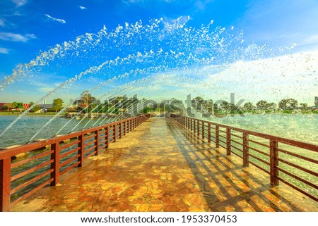 Bridge with fountain in Aspire park, Doha's biggest park, located in Aspire zone, Doha Sports City, Qatar, Middle East. Popular place for Qatari families.