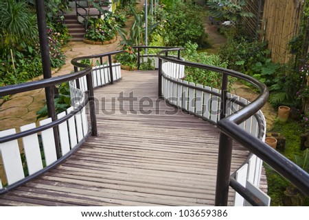 Similar – Image, Stock Photo Steel bridge with wooden railings and forest in the background