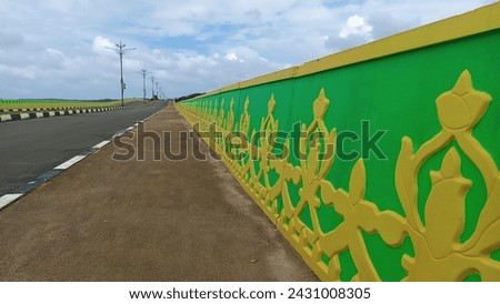 The bridge guardrail is decorated with traditional Malay carvings from Tanjungpinang City