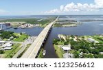 A bridge and highway crossing a huge body of water in Mississippi on a summer day.