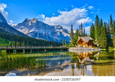 Bridge leading to wooden lodge on Emerald lake with beautiful reflections in the Canadian Rockies of Yoho National Park, British Columbia, Canada.
