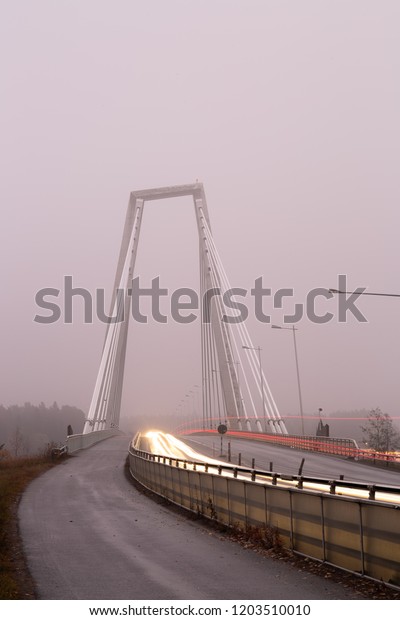 Bridge with Light\
Trails from Cars with\
fog.