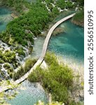 Bridge over a blue lake with a watefall.