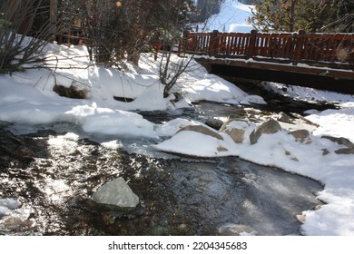 Bridge Over Icy River And Snowbank