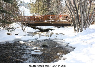 Bridge Over Icy River And Snowbank