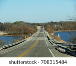 Bridge over a lake on a winter day, with brown leaves in the trees