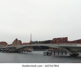 bridge over the river against the background of urban buildings and the rainy sky
 
