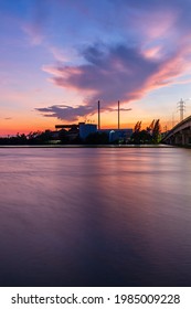 Bridge Over River In The Evening. The Light From The Lamp To The Reflector Surface,Container Terminal In Hamburg, Germany. Bridge Is Called Koehlbrandbruecke - A Bridge About The Harbor.