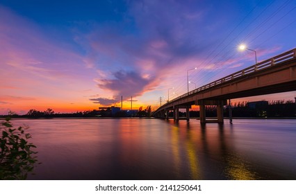 Bridge Over The River In The Evening,The Light From The Lamp To The Reflector Surface,Container Terminal In Hamburg, Germany. Bridge Is Called Koehlbrandbruecke - A Bridge About The Harbor. 