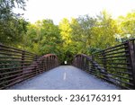 a bridge over a river with metal railing and lush green trees at the Chattahoochee River National Recreation Area in Sandy Springs Georgia	