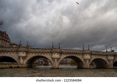 Bridge over the river in Paris and dramatic sky.
