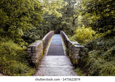 A Bridge Over A River At The Roe Valley Country Park In Northern Ireland.