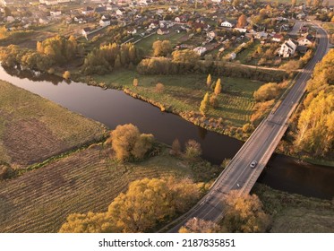 Bridge Over A Road And River In The Countryside. Country Houses At River In Rural. Building A Home In Country. Village With Wooden House. Suburban House In Rural On Sunset In Autumn Colors. Leaf Fall.