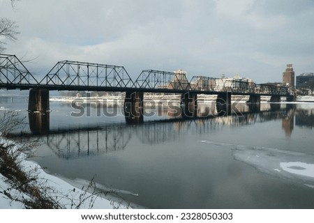 bridge over the Susquehanna River, with it's reflection, in the winter. Harrisburg city in the background.