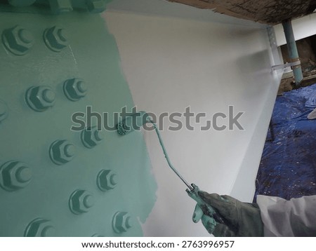 Bridge painting process: Applying a final protective topcoat to steel girders