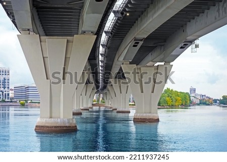Bridge piers, perspective in St Petersburg, Russia. Bottom view of concrete pillars of the bridge over the river