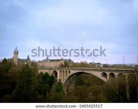 Bridge Pont adolphe in Luxemburg city against a dark blue sky