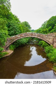 Beggar’s bridge, is a single track medieval packhorse bridge in Glaisdale, Yorkshire. Built by Tom Ferris in 1619, parts are from a former bridge of the 14th century. Single arch over the river Esk. - Shutterstock ID 2181613509