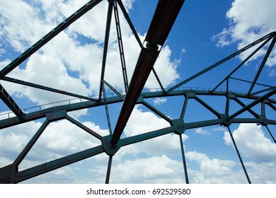 Bridge spans with cloudy sky background.