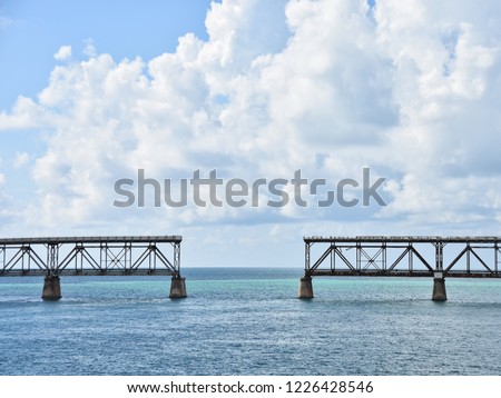 bridge in two halves, not connected, against beautiful sunny and cloudy skies, tropical blue water in Florida Keys