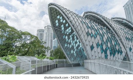 A bridge walkway that offers views of tall buildings. The Petronas Towers in the distance have a curved roof. Decorated with mirrors To be modern, beautiful and provide shade as a background image. - Powered by Shutterstock
