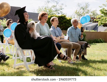 BRIDGEPORT, CT - APRIL 20, 2021: Family Laughing And Smiling At Backyard Covid Graduation Ceremony