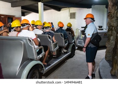 Bridgetown, Barbados - February 3, 2019: Photo Of A Tram With Helmeted Tourists At The Underground Entrance To Harrison's Cave.  The Caves Contain Limestone Stalactites And Stalagmites.  