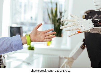 Bridging The Gap. Close Up Of Hands Being Stretched Out Towards Each Other