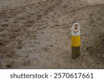 Bridle path, a wooden post with a horseshoe sign that shows the way for horses and their riders in the dunes of Noordwijk aan Zee during the day during winter in the Netherlands with space for text.