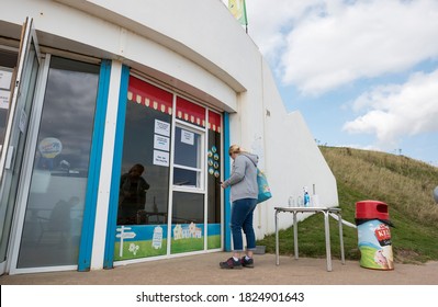 Bridlington, UK 09/13/2020 Woman Outside A Beach Cafe