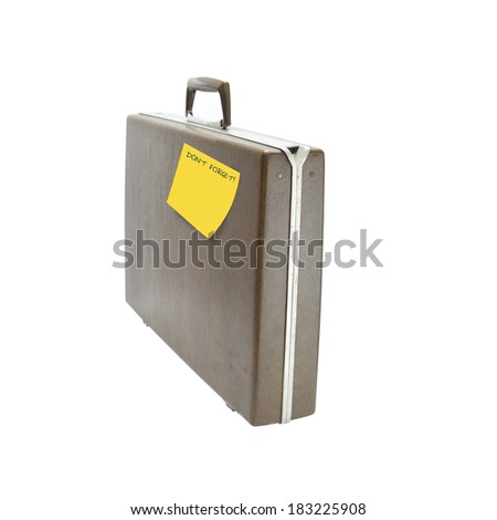Briefcase with Don't Forget Yellow post it note isolated on white background